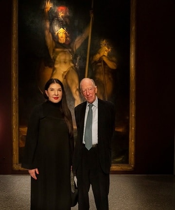 Marina Abramovich and Jacob Rothschild pose in front of Satans Legions Painting